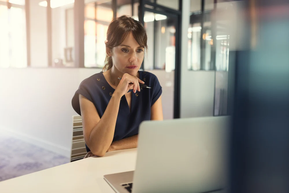 concentrated-middle-aged-woman-working-on-her-laptop