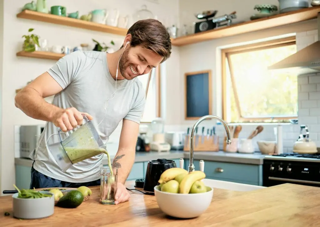 one-fit-young-caucasian-man-pouring-healthy-green-detox-smoothie-from-blender-at-home-1024x727.jpg