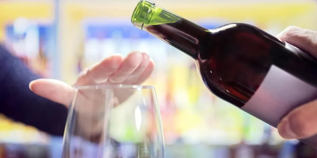 women-s-hand-covering-a-wine-glass-to-stop-the-wine-from-being-poured-in